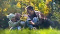 Happy family spending time together in autumn park, picnic outdoors, having fun Royalty Free Stock Photo