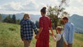 Family spending vacation meadow sunny day. Parents walking grass with children. Royalty Free Stock Photo