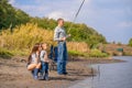 A happy family spends time together they teach their son to fish Royalty Free Stock Photo