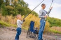 A happy family spends time together they teach their son to fish Royalty Free Stock Photo