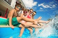 Family splashing water in swimming pool Royalty Free Stock Photo