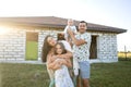 Happy family stand near their new home, construction, dream project, joint construction of a house Royalty Free Stock Photo