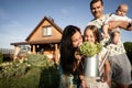 Happy family stand near their new home, joint construction of a house Royalty Free Stock Photo