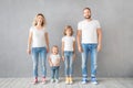 Happy family standing against grey background Royalty Free Stock Photo
