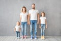 Happy family standing against grey background Royalty Free Stock Photo