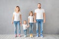 Happy family standing against grey background Royalty Free Stock Photo