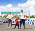 Happy family standing on the go kart race track Royalty Free Stock Photo