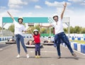 Happy family standing on the go kart race track