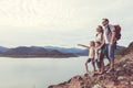 Happy family standing near the lake at the day time. Royalty Free Stock Photo