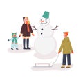 Happy family standing at the snowman on the street