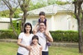 Happy family standing before their house