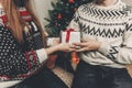happy family in stylish sweaters exchanging gifts in festive room with christmas tree and lights. emotional moments. merry christ Royalty Free Stock Photo