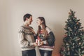 happy family in stylish sweaters exchanging gifts in festive room with christmas tree and lights. emotional moments. merry christ Royalty Free Stock Photo