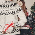 happy family in stylish sweaters exchanging gifts in festive room with christmas tree and lights. emotional moments. merry christ Royalty Free Stock Photo