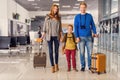 Happy family with suitcases in airport Royalty Free Stock Photo