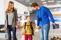 Happy family with suitcases in airport Royalty Free Stock Photo