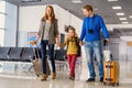 Happy family with suitcases in airport Royalty Free Stock Photo