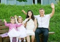 Happy family in summer city park outdoor, pregnant woman, parent and children, bright sunny day and green grass, beautiful people Royalty Free Stock Photo