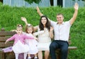 Happy family in summer city park outdoor, pregnant woman, parent and children, bright sunny day and green grass, beautiful people Royalty Free Stock Photo