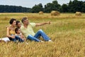 Happy family in summer field. man pointing with finger Royalty Free Stock Photo