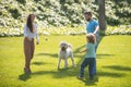 Happy family on summer walk. Father mother and child with dog walking in the Park and enjoying the beautiful nature. Royalty Free Stock Photo