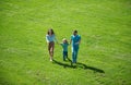 Happy family on summer walk. Father mother and child walking in the Park and enjoying the beautiful nature. Royalty Free Stock Photo