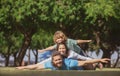 Happy family on summer walk. Father mother and child walking in the park. Parents giving child piggybacks in countryside Royalty Free Stock Photo