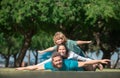 Happy family on summer walk. Father mother and child walking in the park. Parents giving child piggybacks in countryside Royalty Free Stock Photo