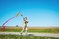 Happy family on summer walk. Young boy flies his kite in an open field. a pictorial analogy for aspirations and aiming Royalty Free Stock Photo