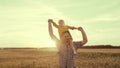 happy family sunset. cheerful father carries little kid daughter his shoulders rays sun. dream childhood. dad kid child Royalty Free Stock Photo