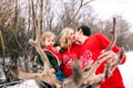 Happy family at sunset. Father, mother and child daughters are having fun and playing on snowy winter walk in nature, kiss. Frost Royalty Free Stock Photo