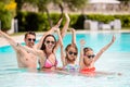 Happy family of four in swimming pool Royalty Free Stock Photo