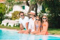 Happy family of four in swimming pool Royalty Free Stock Photo