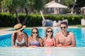 Happy family of four in swimming pool Royalty Free Stock Photo