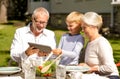 Happy family with tablet pc outdoors Royalty Free Stock Photo