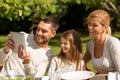 Happy family with tablet pc outdoors Royalty Free Stock Photo