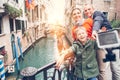 Happy family take a self photo on the bridge over Venecian channel Royalty Free Stock Photo