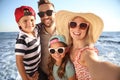 Happy family taking selfie on beach near sea. Summer vacation Royalty Free Stock Photo