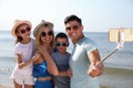 Happy family taking selfie at beach on sunny day Royalty Free Stock Photo