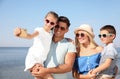 Happy family taking selfie at beach on sunny day Royalty Free Stock Photo