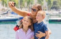 Happy family taking selfie. Mom and her kids take a picture together