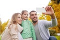 Happy family taking selfie by smartphone outdoors Royalty Free Stock Photo