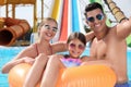 Happy family taking selfie in pool at water park Royalty Free Stock Photo