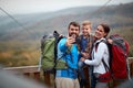 A happy family taking selfie on the top of a watchtower in the forest