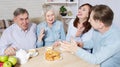 Happy family tea time at nursing home for elderly. Parents with children have fun talk communication and leisure. Senior couple Royalty Free Stock Photo