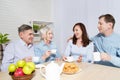 Happy family tea time at nursing home for elderly. Parents with children have fun talk communication and leisure. Senior couple Royalty Free Stock Photo