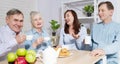 Happy family tea time at nursing home for elderly. Parents with children have fun talk communication and leisure. Senior couple Royalty Free Stock Photo