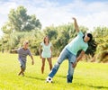 Happy family with teenager playing in soccer