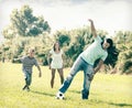 Happy family with teenager playing in soccer