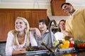 Happy family with teenagers smiling in kitchen Royalty Free Stock Photo